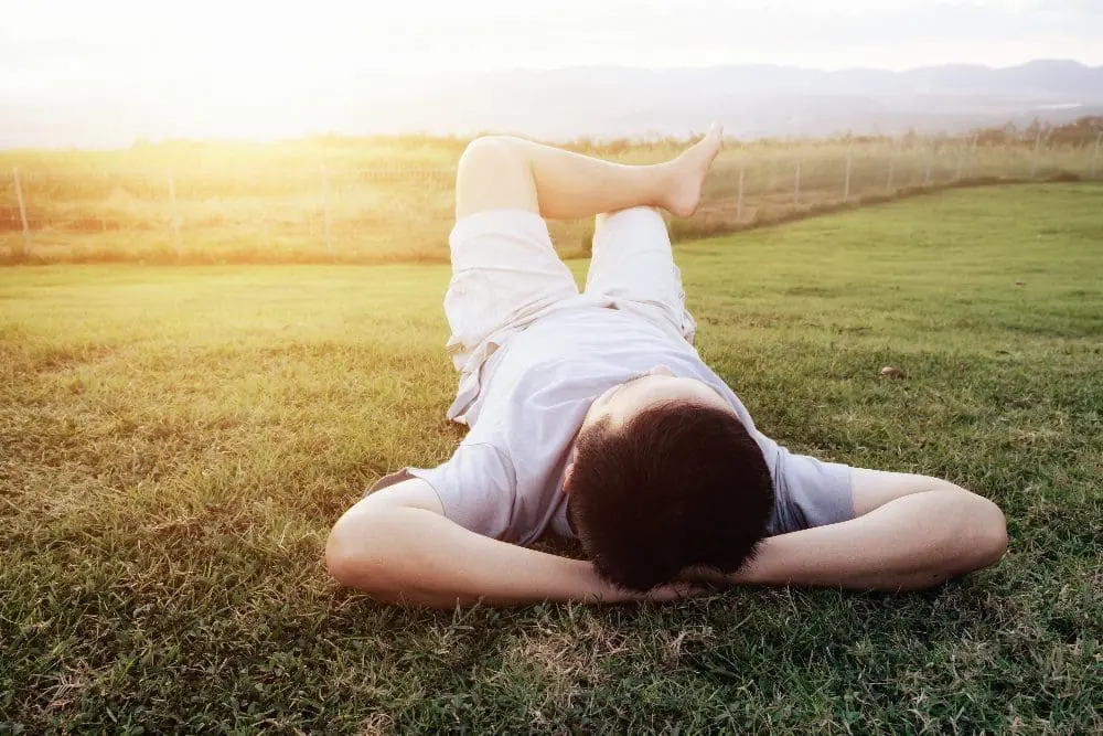 man relaxing on grass
